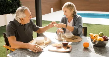 couple in emerald hills enjoying breakfast outside their home
