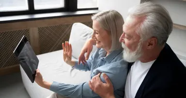 senior couple in los gatos talking to their grandchild via video call